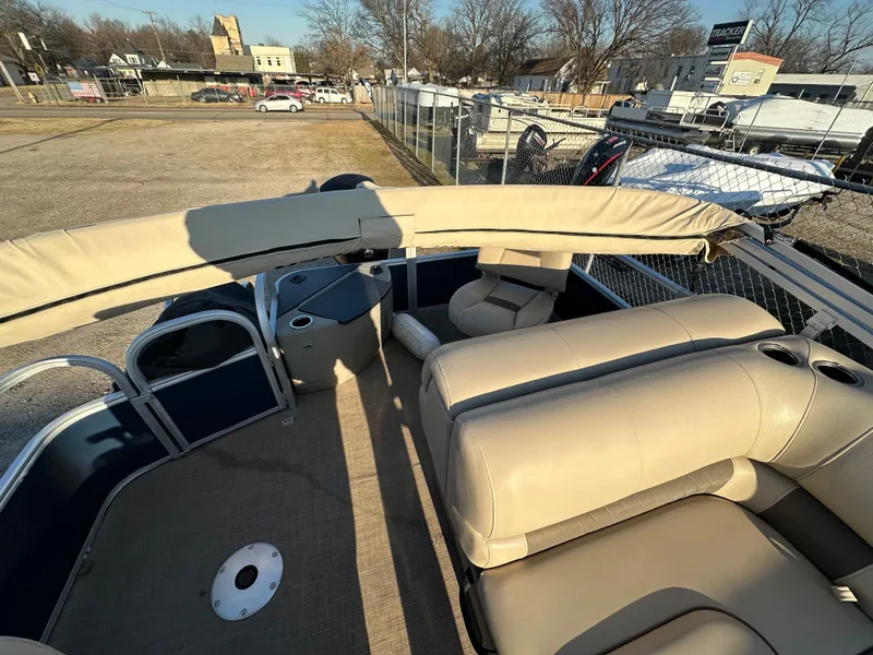 Slide: The Image of 2023 Sun Tracker Fishin' Barge 20 DLX interior with beige seating and open deck. - 8