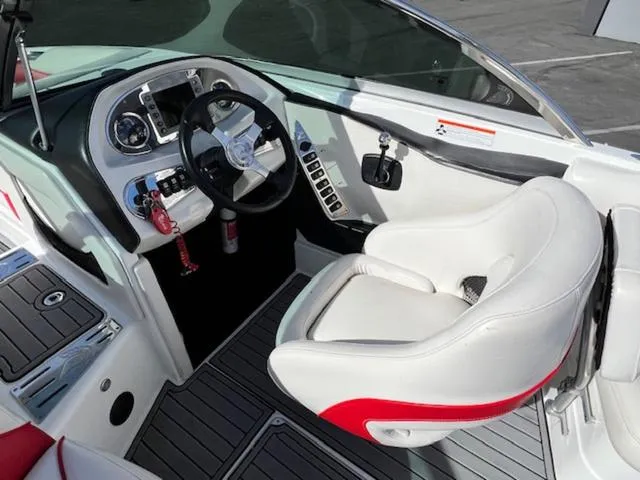 Slide: The Image of Interior of 2011 Centurion ENZO 240 boat, featuring steering wheel and control panel. - 12