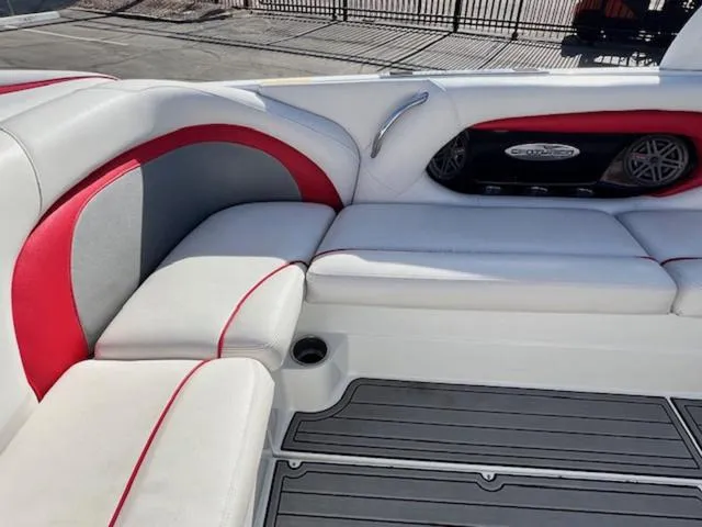 Slide: The Image of Centurion ENZO 240 boat interior, 2011 model, featuring white and red seating with speaker system. - 14