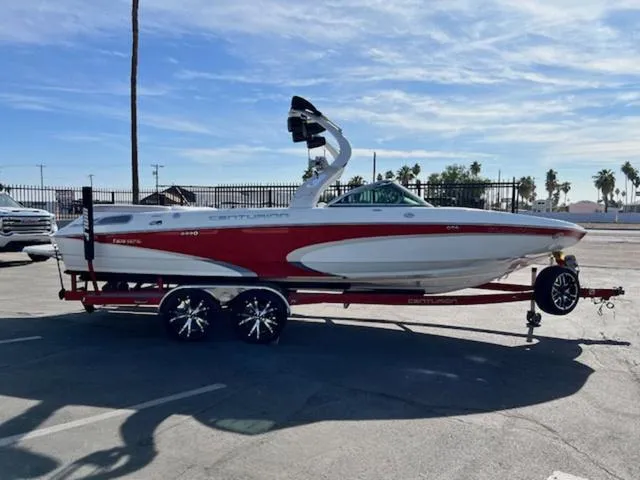 Slide: The Image of 2011 Centurion ENZO 240 boat on trailer, red and white design, parked outdoors. - 5