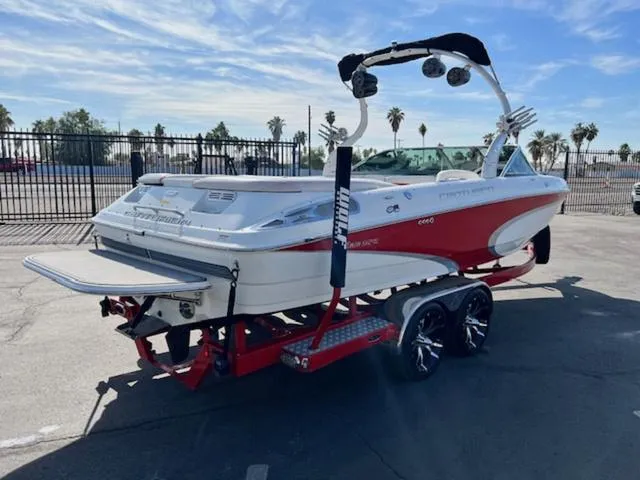Slide: The Image of 2011 Centurion ENZO 240 boat on trailer, red and white, parked outdoors. - 6