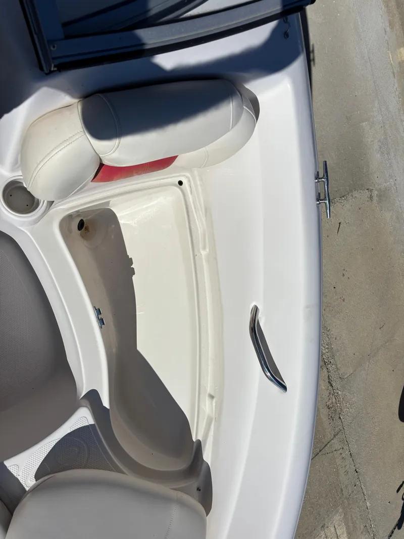 Slide: The Image of 2011 Tracker Tahoe Q5i boat interior with white seating and storage compartment. - 17