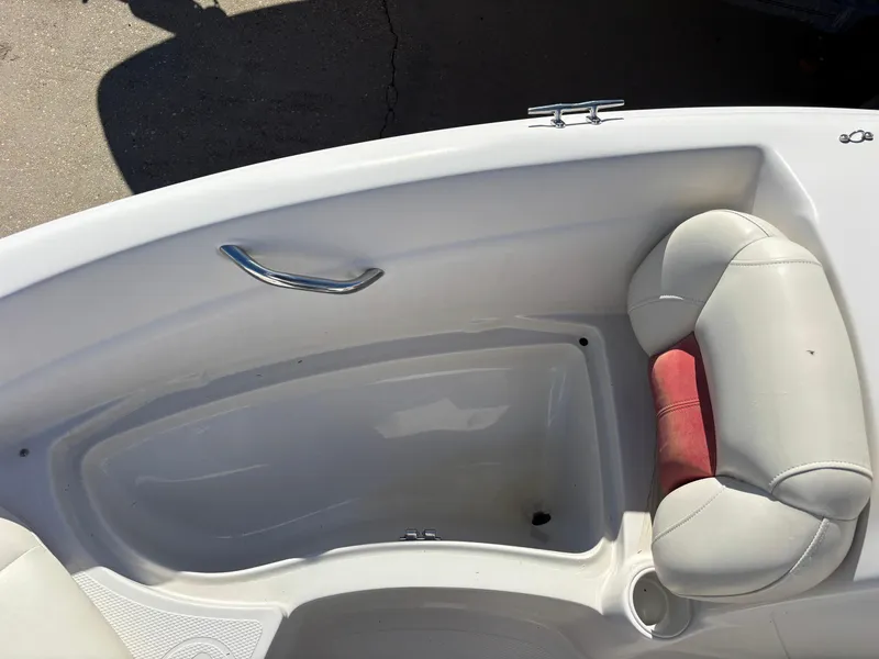 Slide: The Image of 2011 Tracker Tahoe Q5i boat interior with white seating and storage compartment. - 19