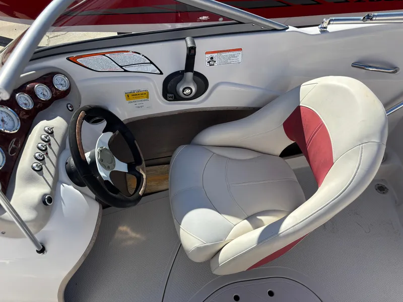 Slide: The Image of 2011 Tracker Tahoe Q5i boat interior with steering wheel and cushioned seat. - 20