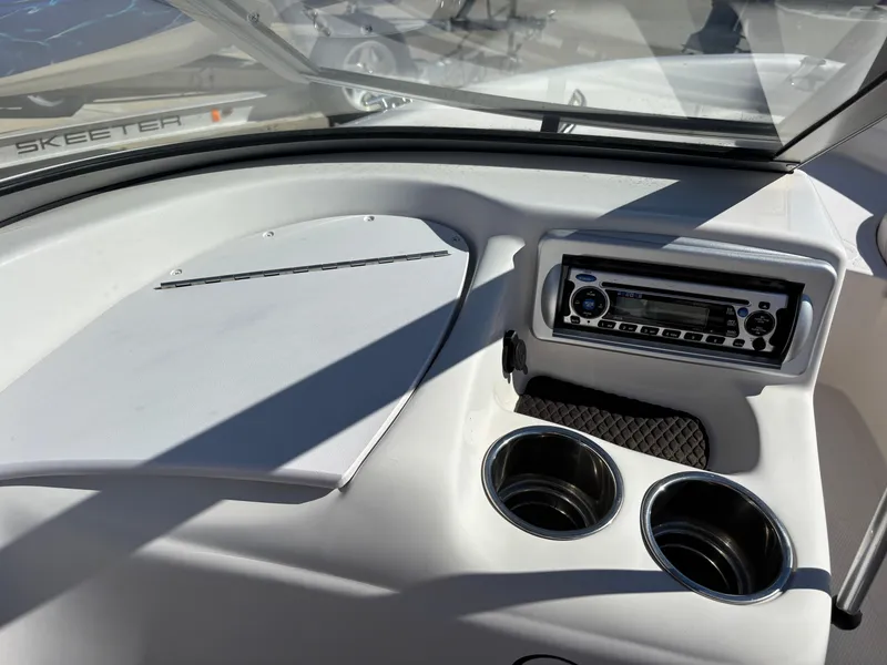 Slide: The Image of Dashboard of 2011 Tracker Tahoe Q5i boat with stereo and cup holders. - 23