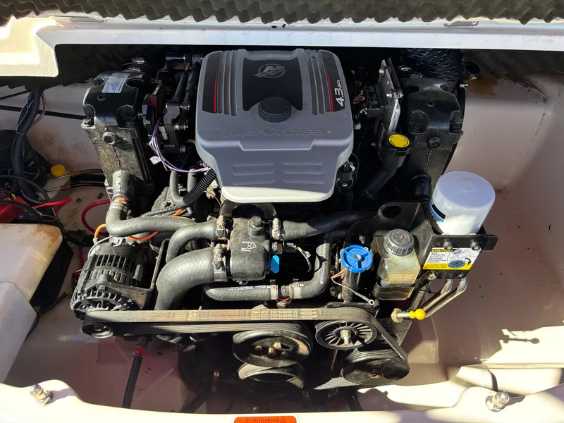 Slide: The Image of 2011 Tracker Tahoe Q5i engine compartment, showcasing a well-maintained motor. - 25