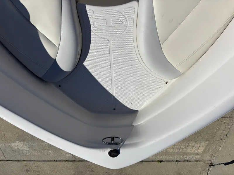 Slide: The Image of 2011 Tracker Tahoe Q5i boat interior with white seating and textured flooring. - 26