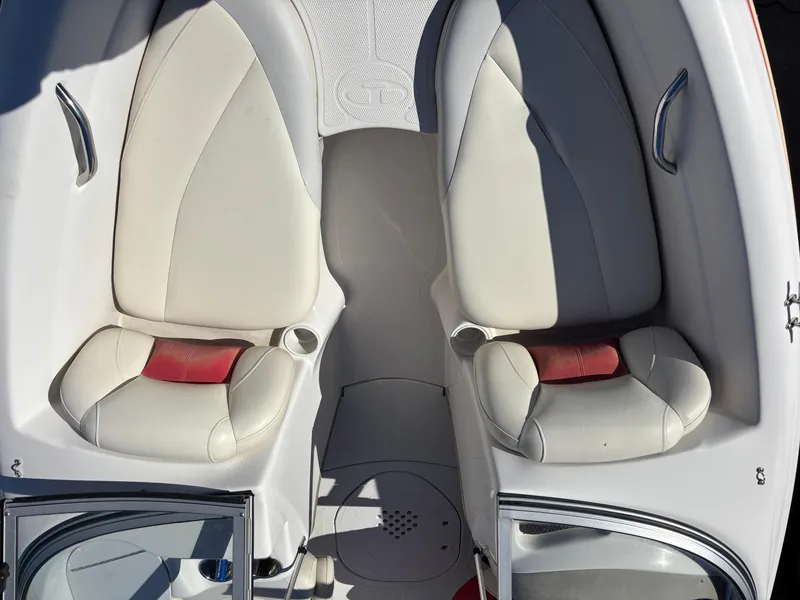 Slide: The Image of 2011 Tracker Tahoe Q5i boat interior with two beige seats and red accents. - 28