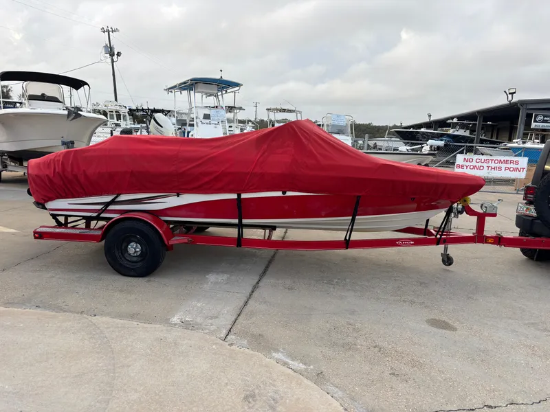 Slide: The Image of 2011 Tracker Tahoe Q5i boat with red cover on trailer at marina. - 3