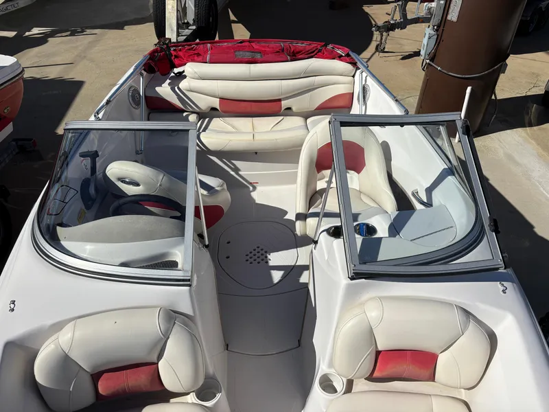 Slide: The Image of 2011 Tracker Tahoe Q5i boat interior with white and red seating. - 30