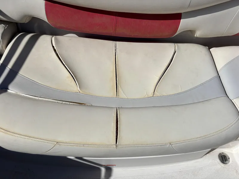 Slide: The Image of 2011 Tracker Tahoe Q5i boat seat with red and white upholstery. - 34