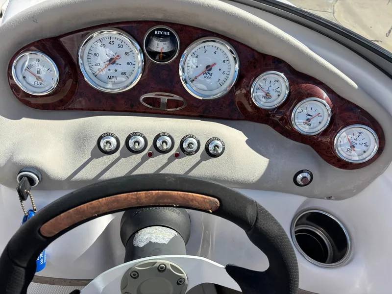 Slide: The Image of Dashboard of a 2011 Tracker Tahoe Q5i boat with gauges and steering wheel. - 38