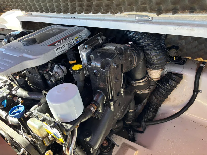 Slide: The Image of Engine compartment of a 2011 Tracker Tahoe Q5i boat, showing detailed components. - 44