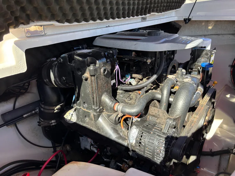Slide: The Image of 2011 Tracker Tahoe Q5i engine compartment with visible components and wiring. - 46