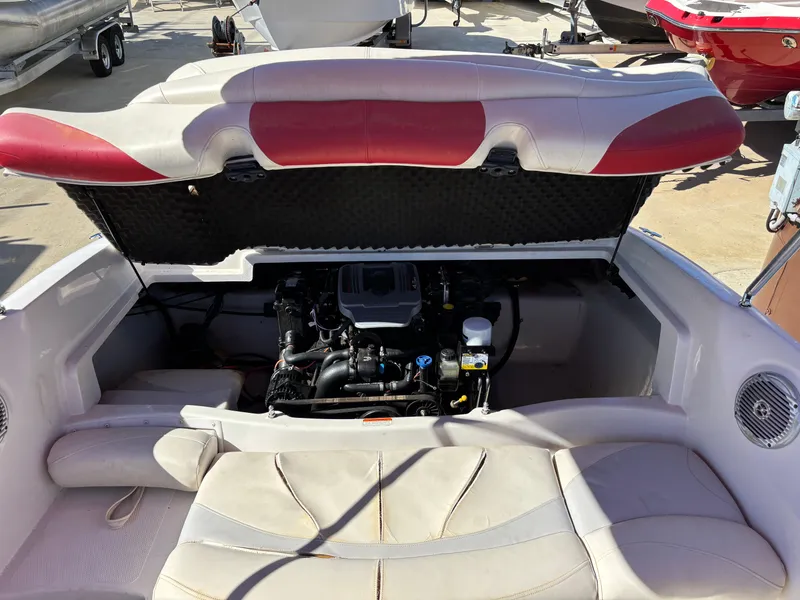 Slide: The Image of 2011 Tracker Tahoe Q5i boat engine compartment with open hatch, revealing interior components. - 47