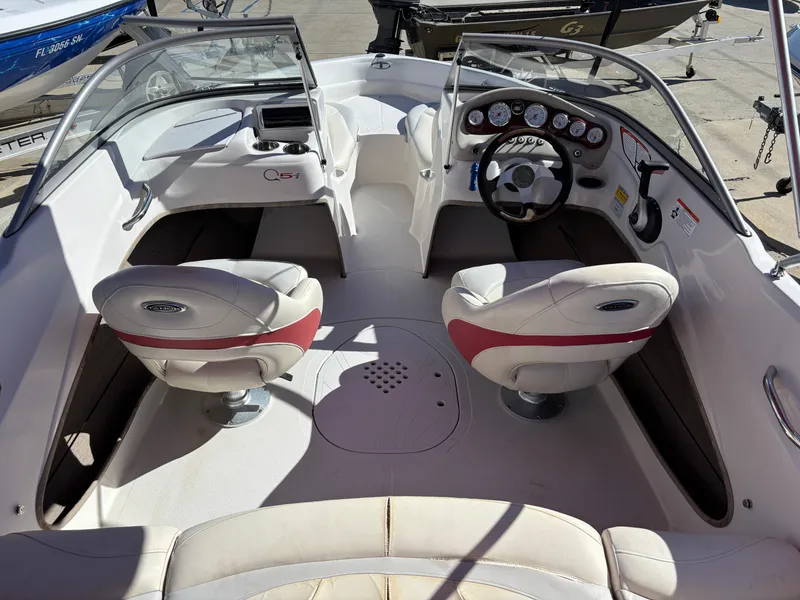 Slide: The Image of 2011 Tracker Tahoe Q5i boat interior with dual seats and dashboard controls. - 49