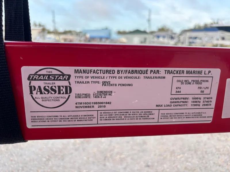 Slide: The Image of Label on 2011 Tracker Tahoe Q5i trailer, showing inspection pass and specifications. - 5