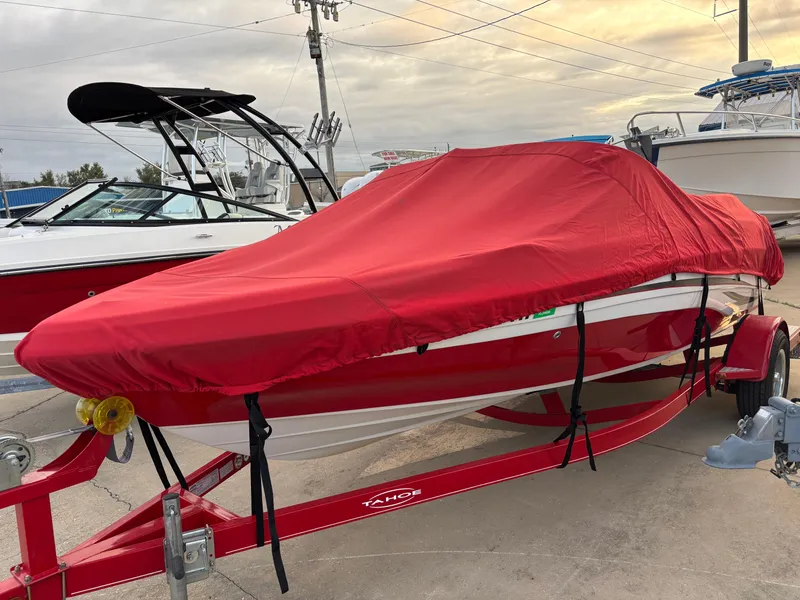 Slide: The Image of 2011 Tracker Tahoe Q5i boat with red cover on trailer. - 6