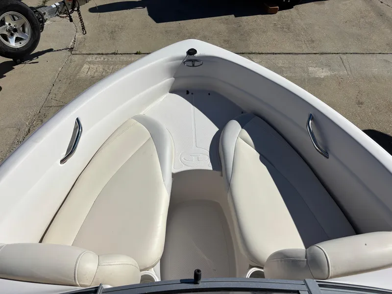 Slide: The Image of 2011 Tracker Tahoe Q5i boat interior with white seating and stainless steel handles. - 7