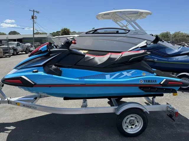 Slide: The Image of 2024 Yamaha Waverunner VX Deluxe with Audio, blue, on trailer, parked outdoors. - 5