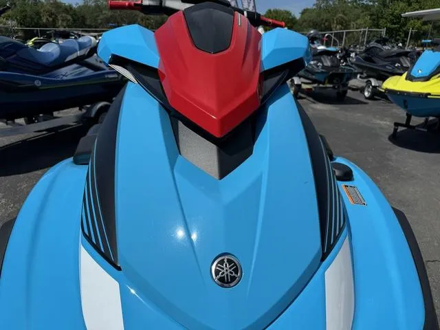 Slide: The Image of 2024 Yamaha Waverunner VX Deluxe with Audio, blue and red design, parked outdoors. - 9