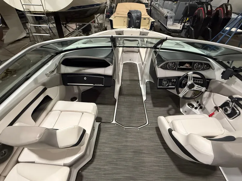 Slide: The Image of 2018 Four Winns H210 boat interior with modern dashboard and seating. - 12
