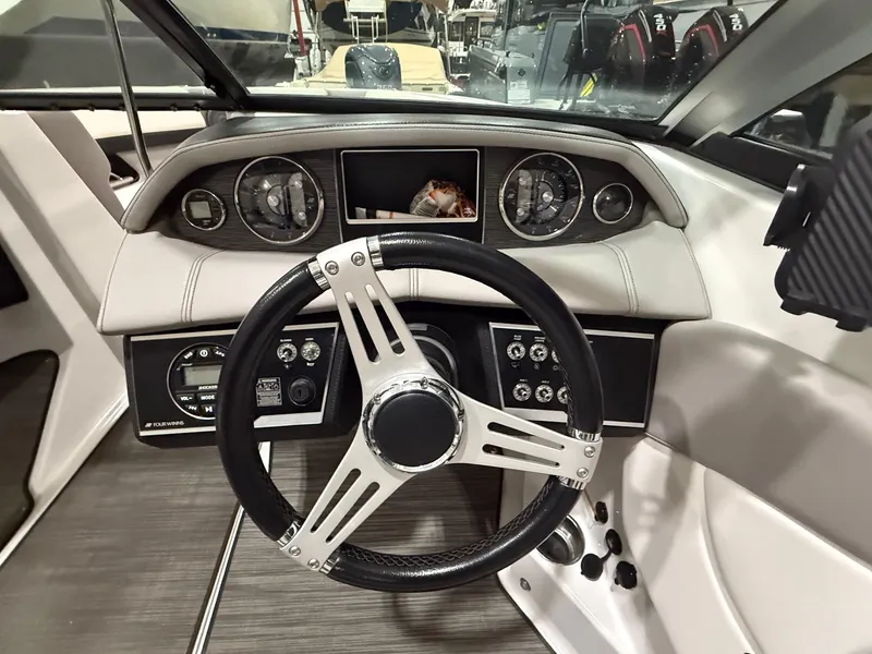 Slide: The Image of 2018 Four Winns H210 boat dashboard with steering wheel and instrument panel. - 15