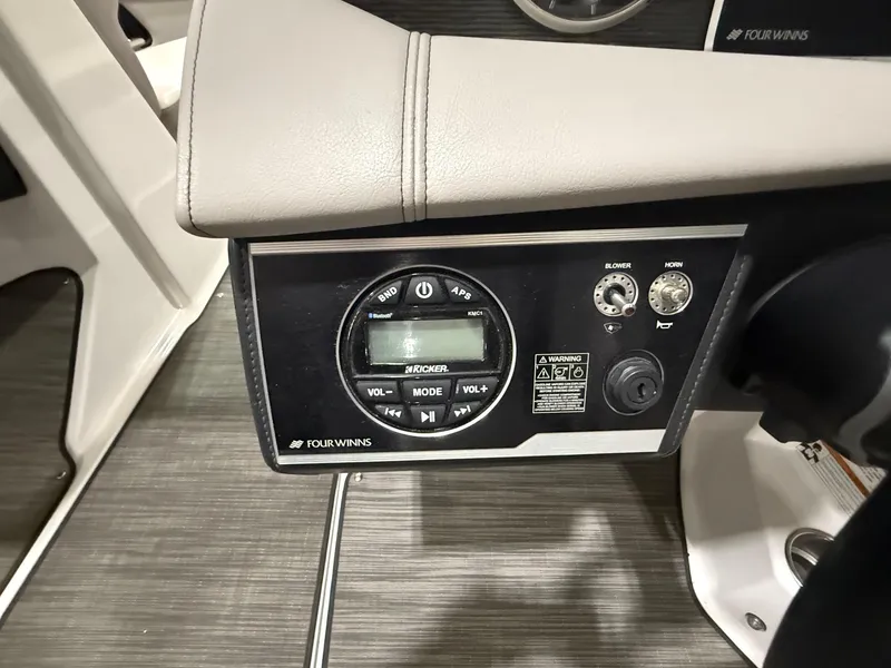 Slide: The Image of Control panel of 2018 Four Winns H210 boat with audio system and controls. - 16