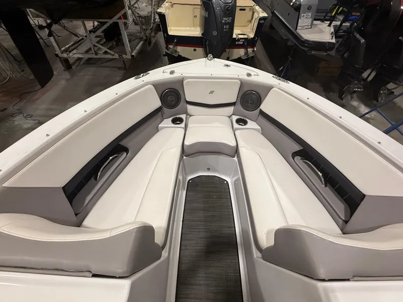Slide: The Image of 2018 Four Winns H210 boat interior with white seating and speakers. - 19