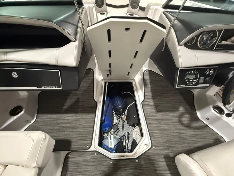 Slide: The Image of 2018 Four Winns H210 boat interior with open storage compartment. - 22