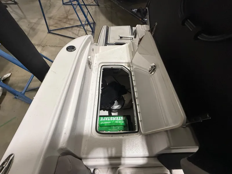 Slide: The Image of Open storage compartment on 2018 Four Winns H210 boat with items inside. - 24
