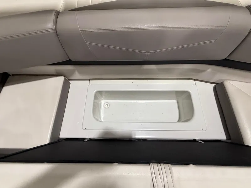 Slide: The Image of 2018 Four Winns H210 boat interior with built-in storage compartment. - 25