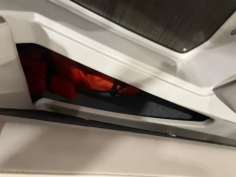 Slide: The Image of Storage compartment in 2018 Four Winns H210 boat with life jackets. - 29