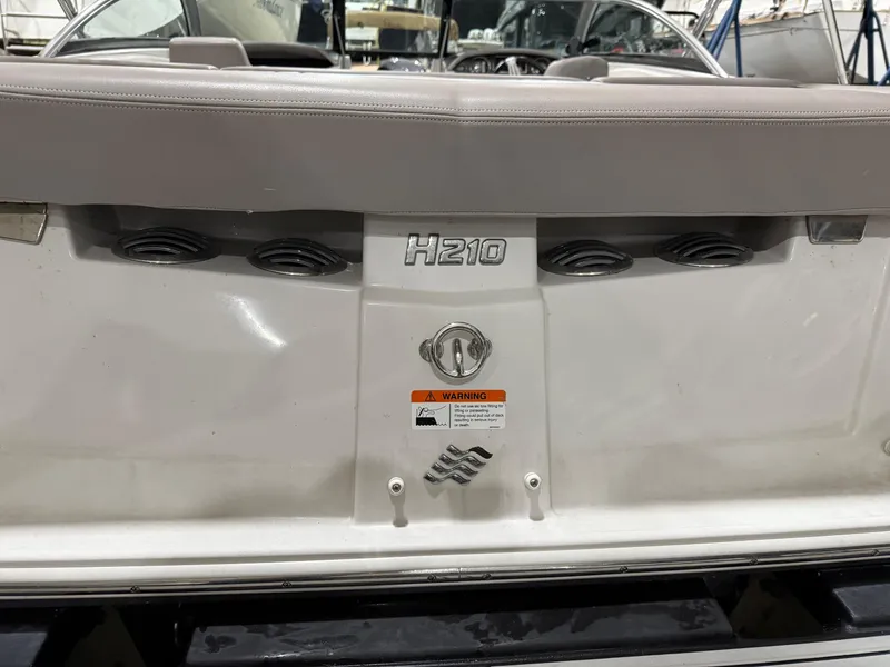 Slide: The Image of 2018 Four Winns H210 boat rear view with seating and model emblem. - 31