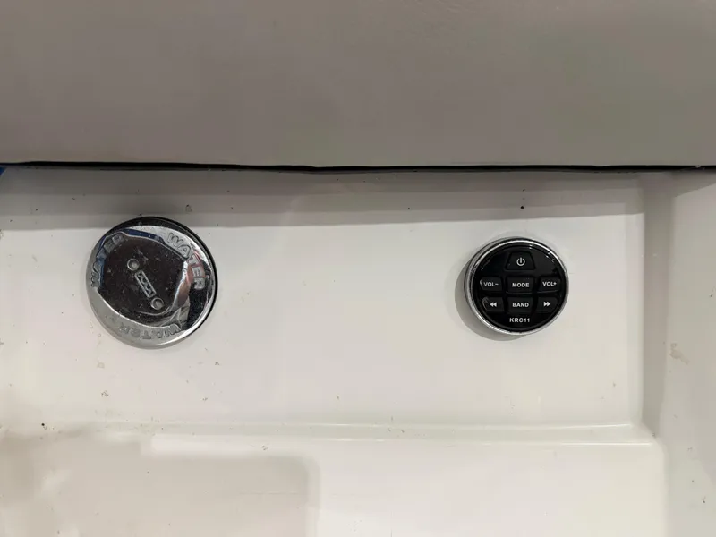 Slide: The Image of 2018 Four Winns H210 boat dashboard controls, featuring a stereo system interface. - 32