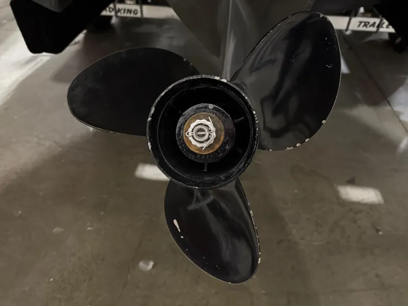 Slide: The Image of 2018 Four Winns H210 boat propeller, close-up view in a garage setting. - 37