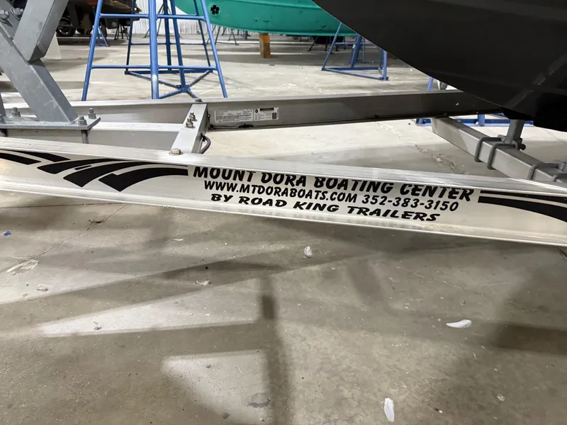 Slide: The Image of Trailer for Four Winns H210 boat, Mount Dora Boating Center branding. - 38