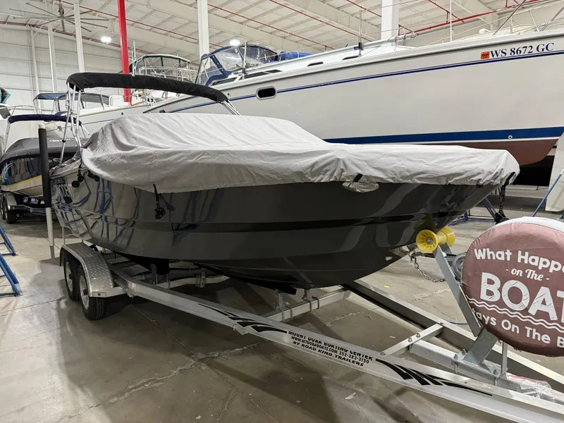 Slide: The Image of 2018 Four Winns H210 boat on trailer, covered, in indoor storage facility. - 4