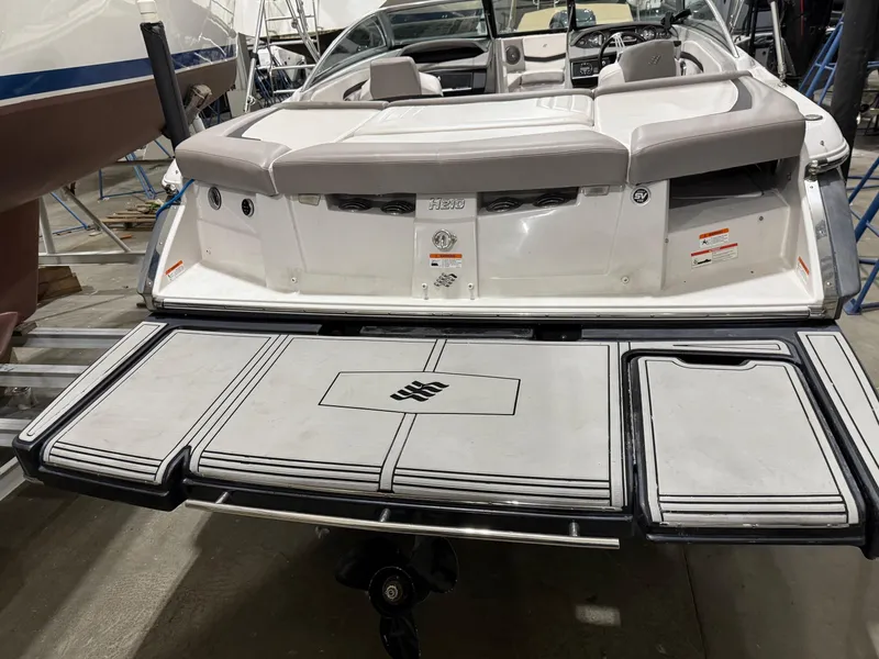 Slide: The Image of 2018 Four Winns H210 boat with spacious rear deck and seating area. - 7