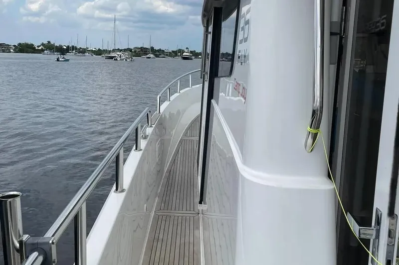 Slide: The Image of 2015 Sargo 36 Fly yacht on calm waters, showcasing sleek deck design. - 11