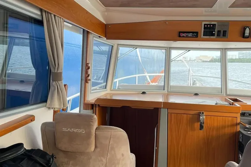 Slide: The Image of Interior view of 2015 Sargo 36 Fly boat, featuring helm and panoramic windows. - 14