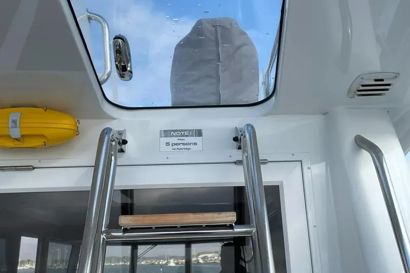 Slide: The Image of Interior view of a 2015 Sargo 36 Fly boat, featuring a ladder and hatch. - 8