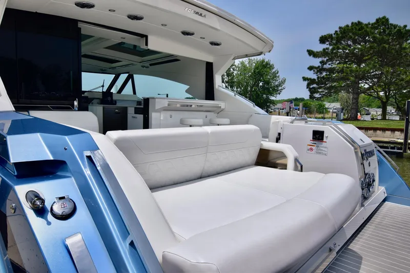 Slide: The Image of 2023 Formula 500 Super Sport Crossover luxury yacht interior with white seating and modern amenities. - 14
