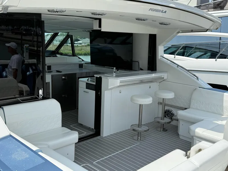 Slide: The Image of 2023 Formula 500 Super Sport Crossover yacht interior with seating and bar area. - 19