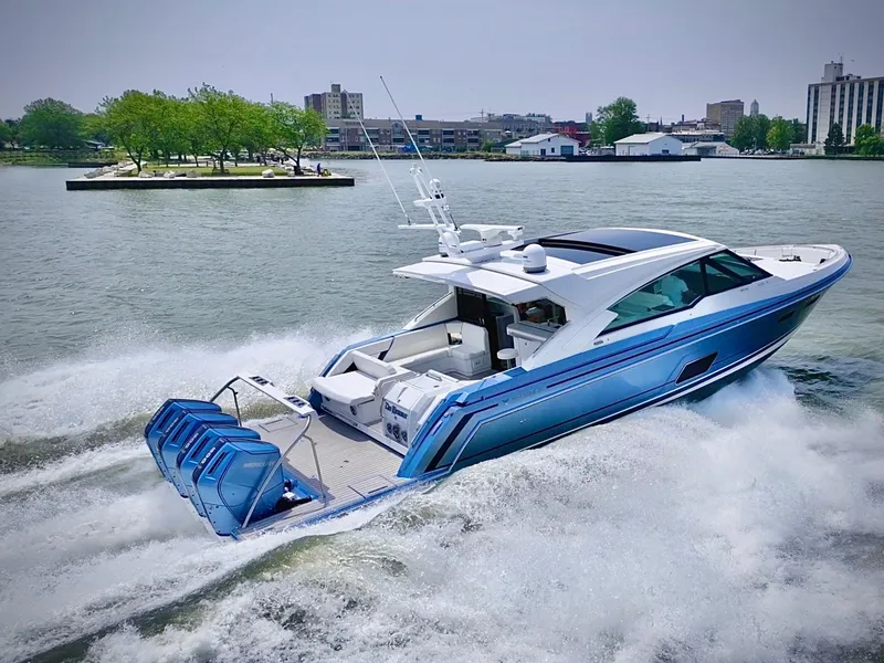 Slide: The Image of 2023 Formula 500 Super Sport Crossover yacht cruising on a lake near a cityscape. - 2