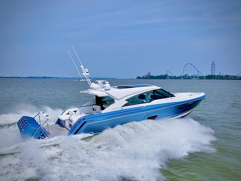 Slide: The Image of 2023 Formula 500 Super Sport Crossover cruising on water with amusement park in background. - 4