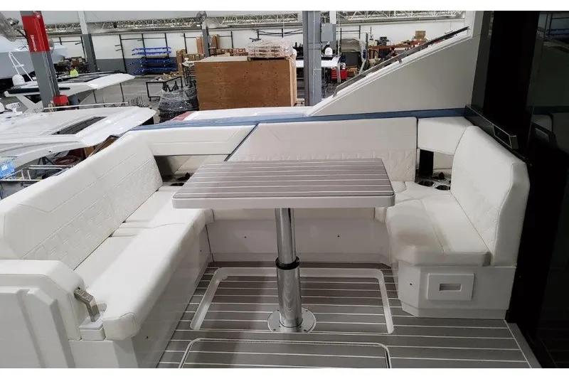 Slide: The Image of 2023 Formula 500 Super Sport Crossover yacht interior with sleek seating and table. - 46