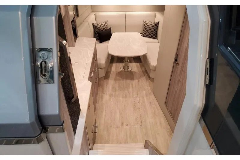 Slide: The Image of Interior of 2023 Formula 500 Super Sport Crossover, featuring modern seating and table arrangement. - 54