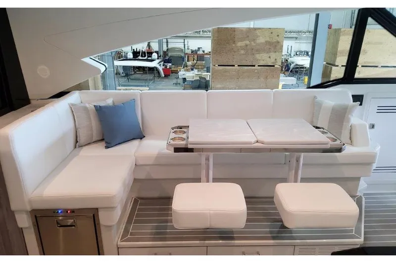 Slide: The Image of 2023 Formula 500 Super Sport Crossover interior with white seating and table setup. - 57