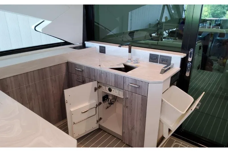 Slide: The Image of 2023 Formula 500 Super Sport Crossover yacht interior kitchen with modern cabinetry and sink. - 64